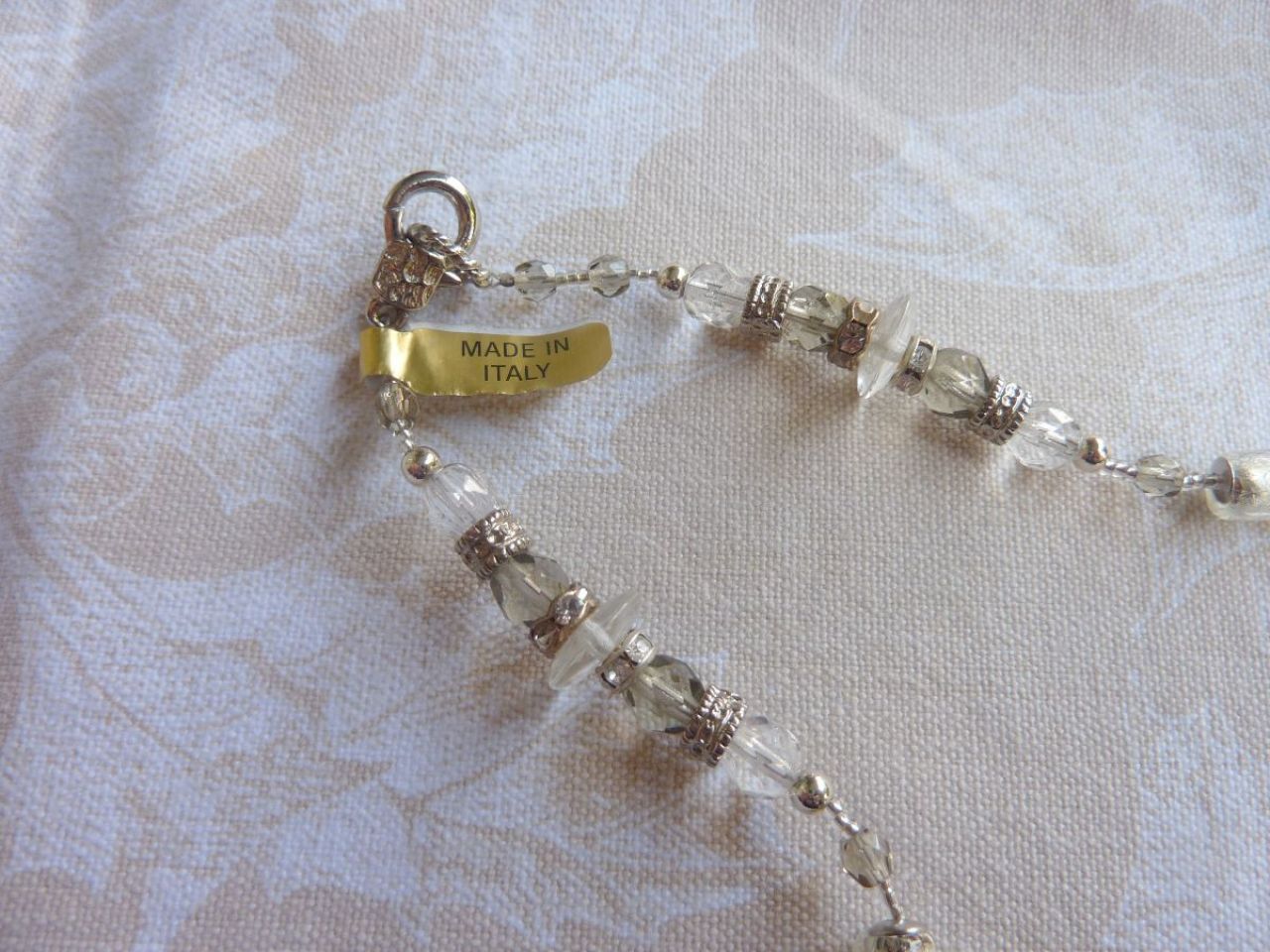collier composé  avec perles  en verre de divers formes, couleur argent et gris claire